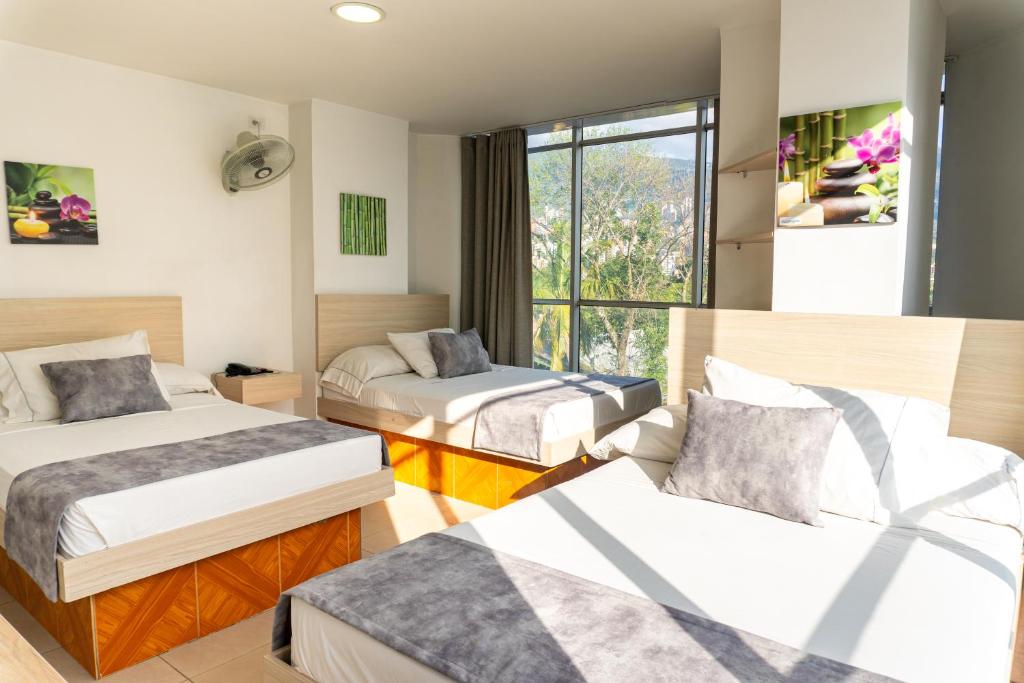 Postel nebo postele na pokoji v ubytování Hotel Alcaravan Medellín