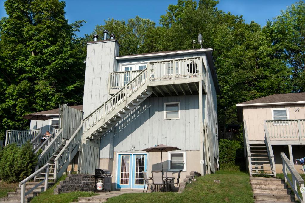 a building with stairs on the side of it at Newly Renovated 2 Bedroom Beach Front Condo 2C in Lanark