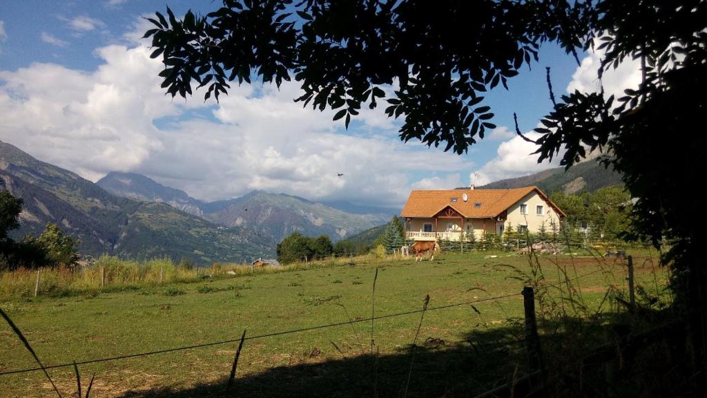 a house in the middle of a field with a house at les Gites de l’E.D.E. in Saint-Léger-les-Mélèzes