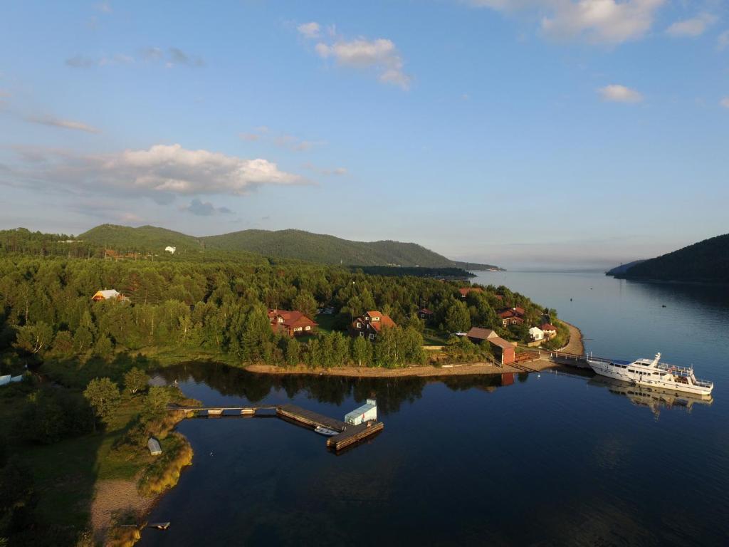 a large body of water with a boat in the distance at Baikal Seasons Hotel in Listvyanka