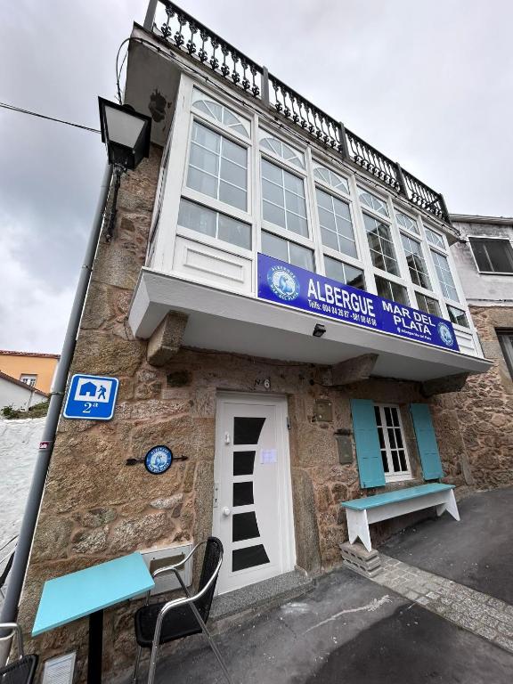 a building with a sign on the front of it at Albergue Mar del Plata in Finisterre