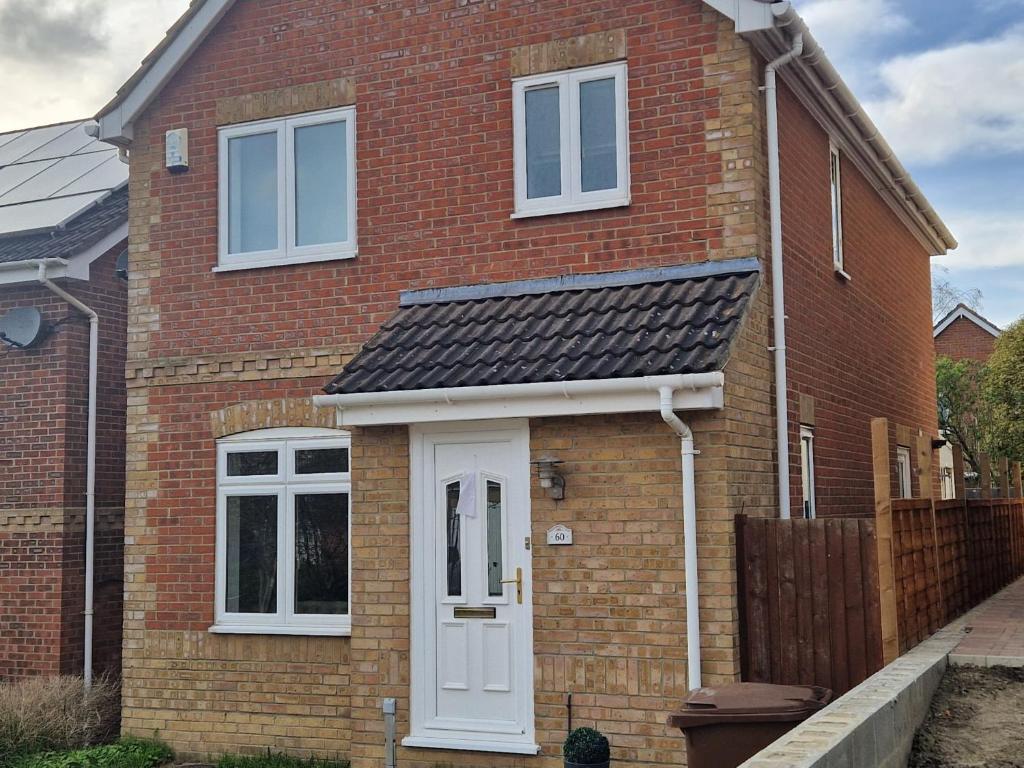 a red brick house with a white door at Captivating 3-Bed House in Strood Rochester Kent in Rochester