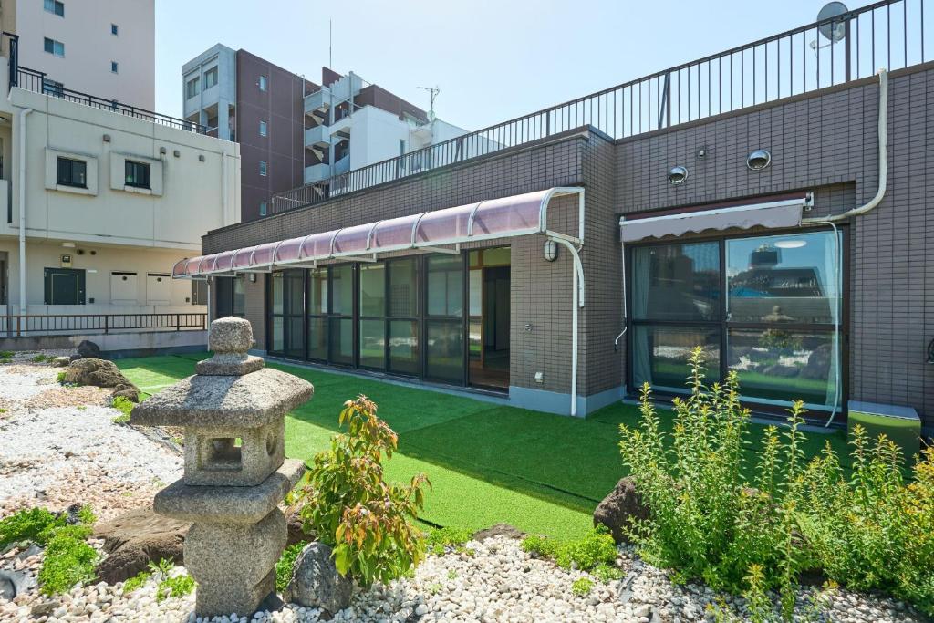 a building with a garden in front of it at Near Shibuya! 150 sq m Private floor & Japanese garden in Tamagawa