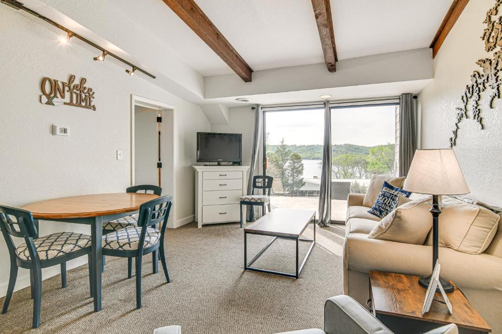 a living room with a table and a couch and a table at Kimberling City Condo with Lake Views and Pool Access in Kimberling City