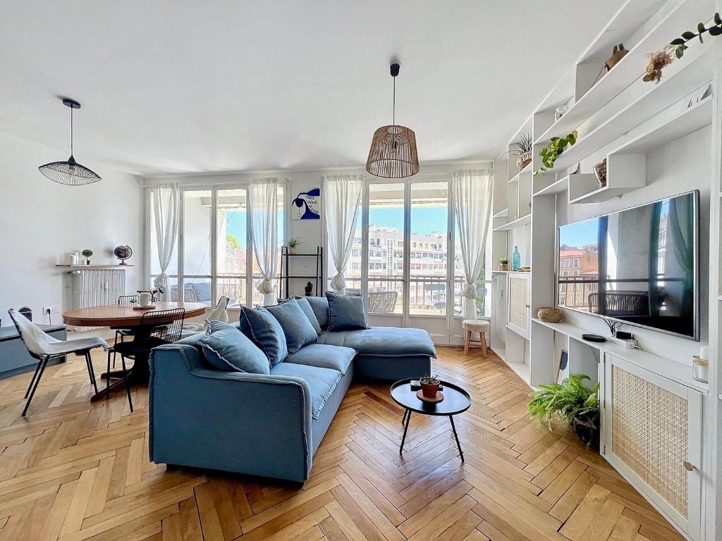 un salon avec un canapé bleu et une table dans l'établissement Appartement avec Balcon - Hyper Central & Lumineux - Les Frères de la Loc', à Marseille