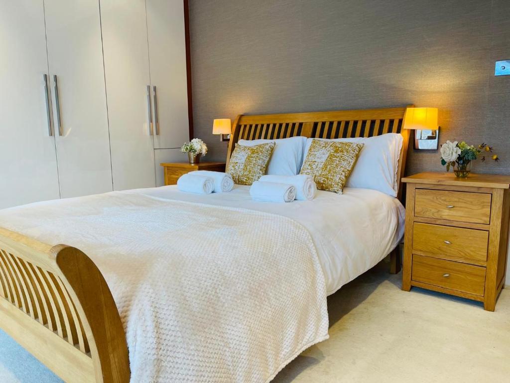 a bedroom with a large bed with towels on it at Luxury Stay in Orpington
