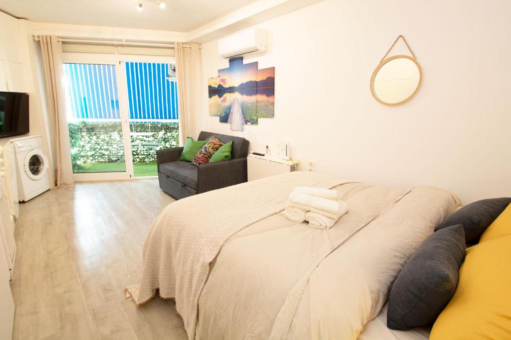 a bedroom with a large bed and a couch at ELEVANA in Fuengirola