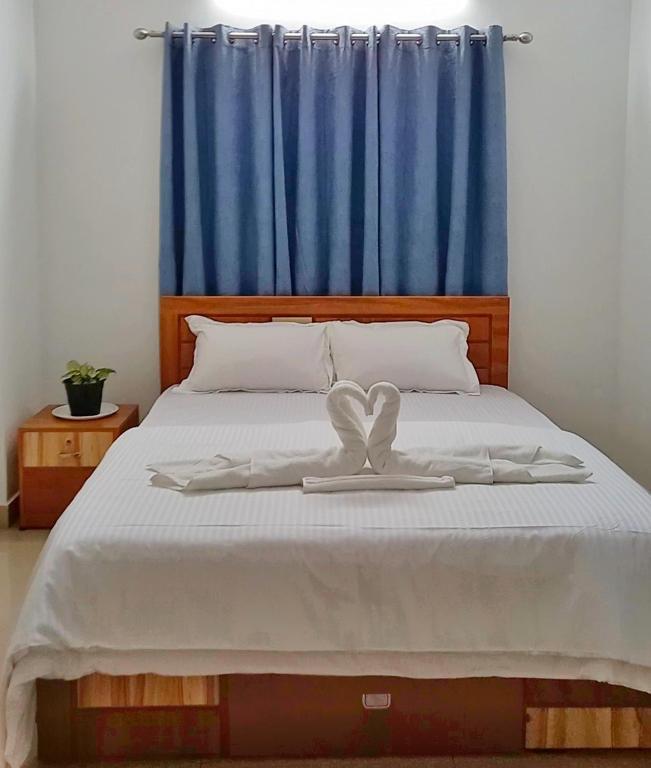 Ένα ή περισσότερα κρεβάτια σε δωμάτιο στο CM homestay
