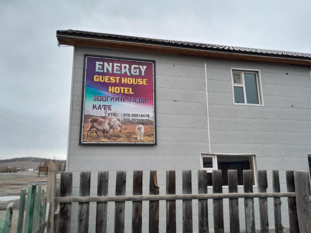 a building with a sign on the side of it at Energy Guest House in Khyaktil