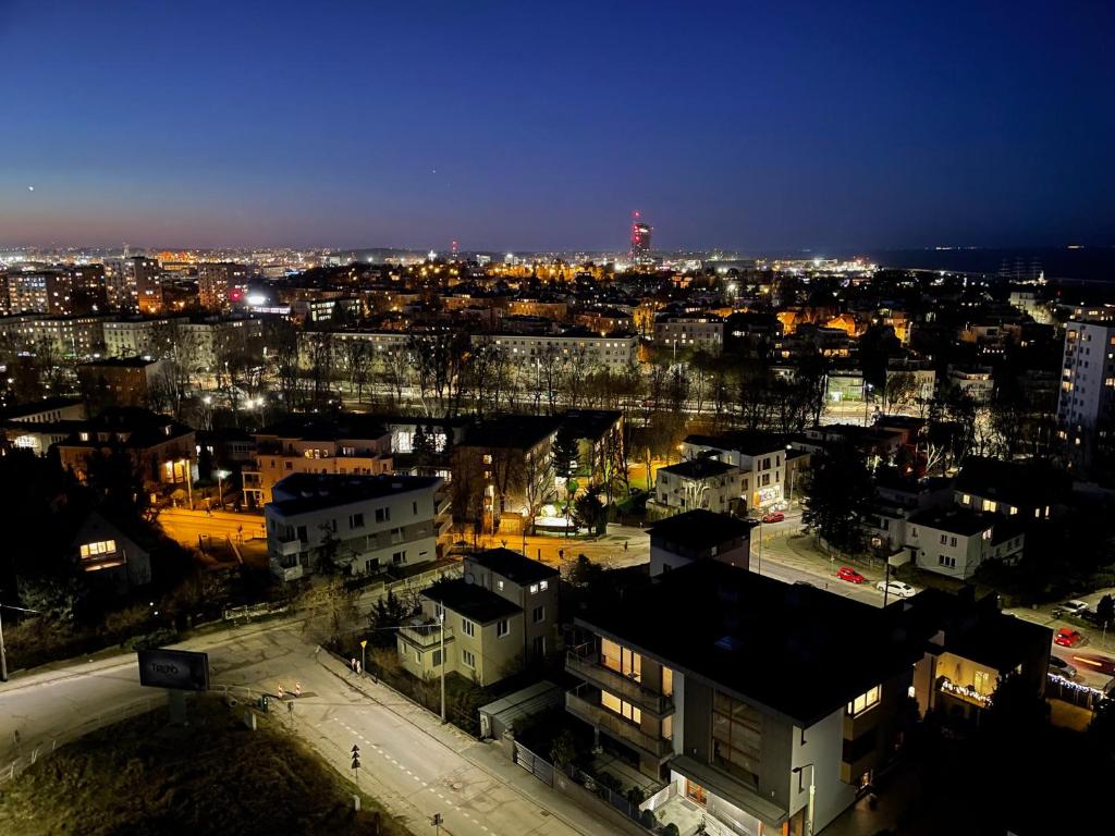 a view of a city at night with a bridge at Gdynia Riviera Hills in Gdynia