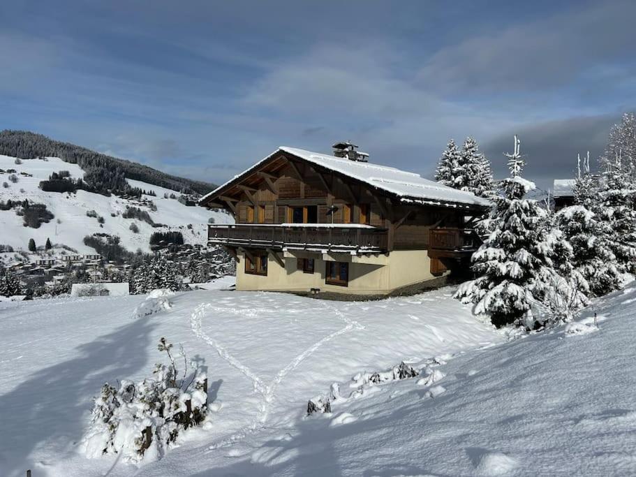 a log cabin in the snow with snow at Chalet familial sur les pistes in Megève