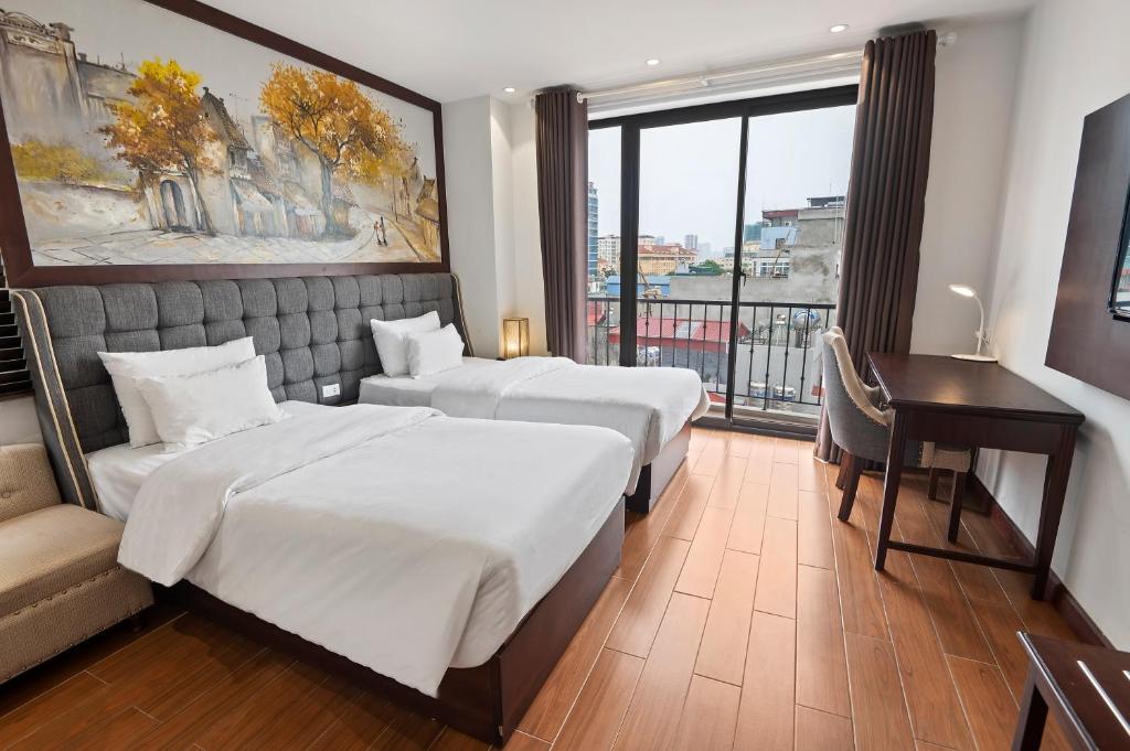 Postel nebo postele na pokoji v ubytování 22Land Residence Hotel & Spa Hanoi