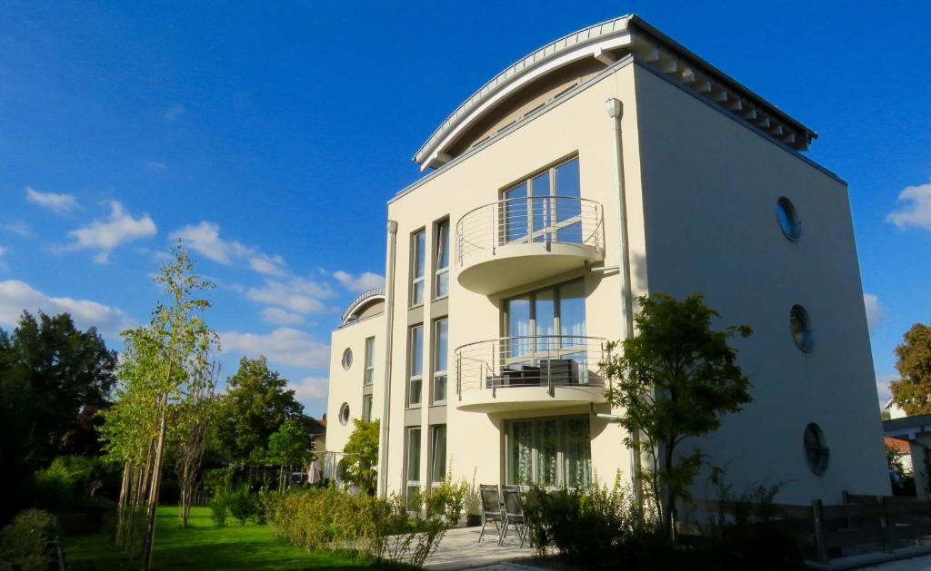 a white building with balconies on the side of it at Monopol Apartments in Wernigerode