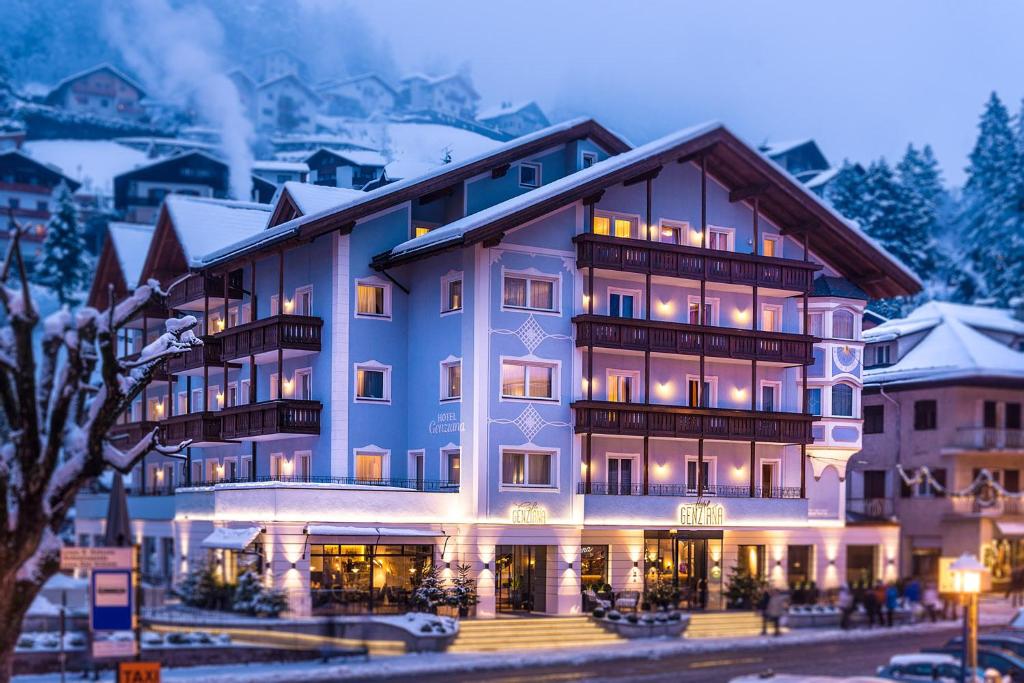 a hotel in the mountains with snow at Hotel Genziana in Ortisei
