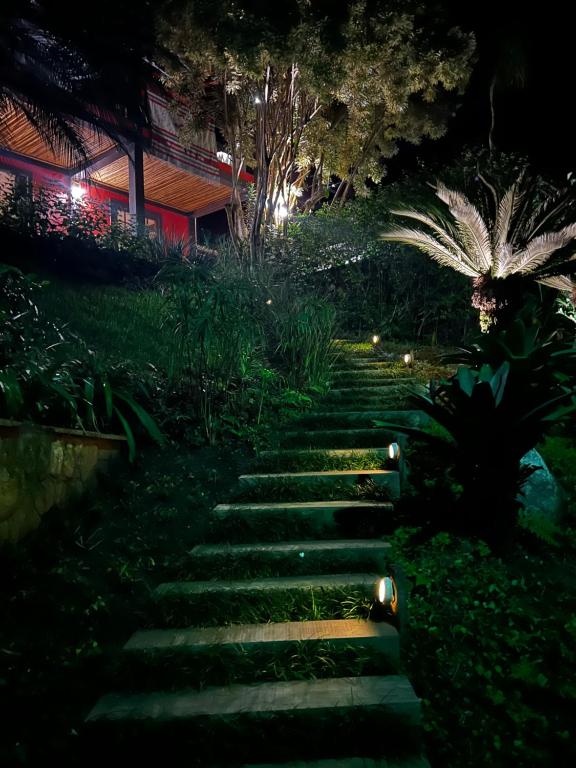 um caminho de jardim à noite com luzes em Casa de condomínio na praia de Toque-toque Pequeno em Toque Toque Pequeno