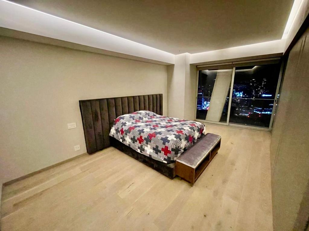 a bedroom with a bed and a window at Departamento B, Santa Fe, Piso 42 in Mexico City