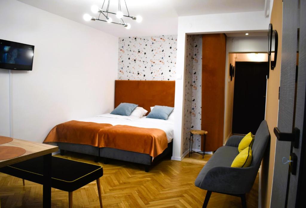 a bedroom with a bed and a table and chairs at Apartament MCK 100m, Spodek 150m, NOSPR in Katowice