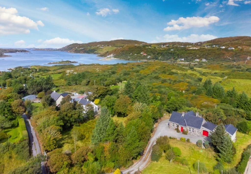 an aerial view of a house on a hill next to a lake at Sycamore Cottage in Clifden