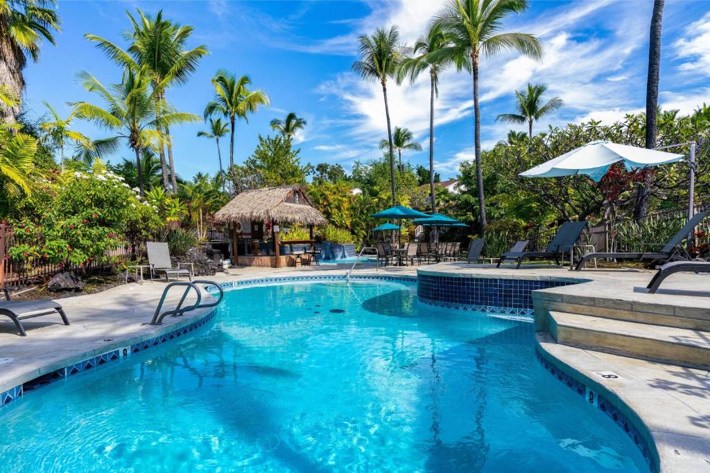 a swimming pool at a resort with palm trees at "Makani Moana" at Keauhou Resort #104, Entire townhome close to Kona in Kailua-Kona