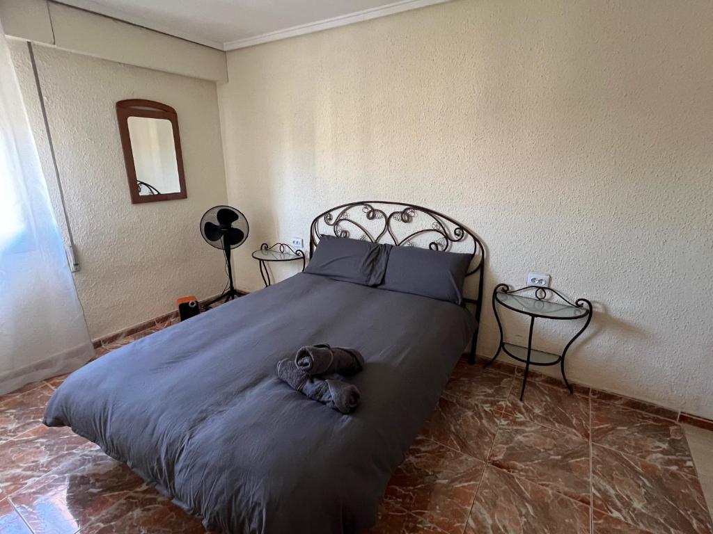a bedroom with a bed with a teddy bear on it at Piso Completo cerca de Artes Y Ciencias in Valencia