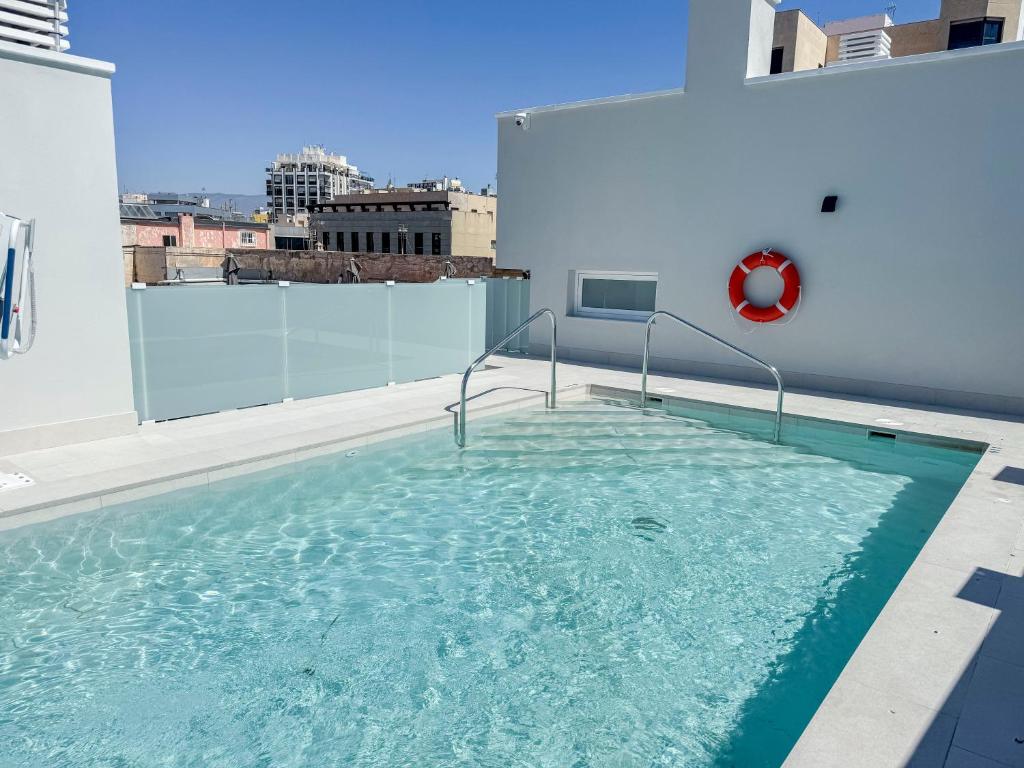 a swimming pool on the roof of a building at Torreluz SUITES in Almería