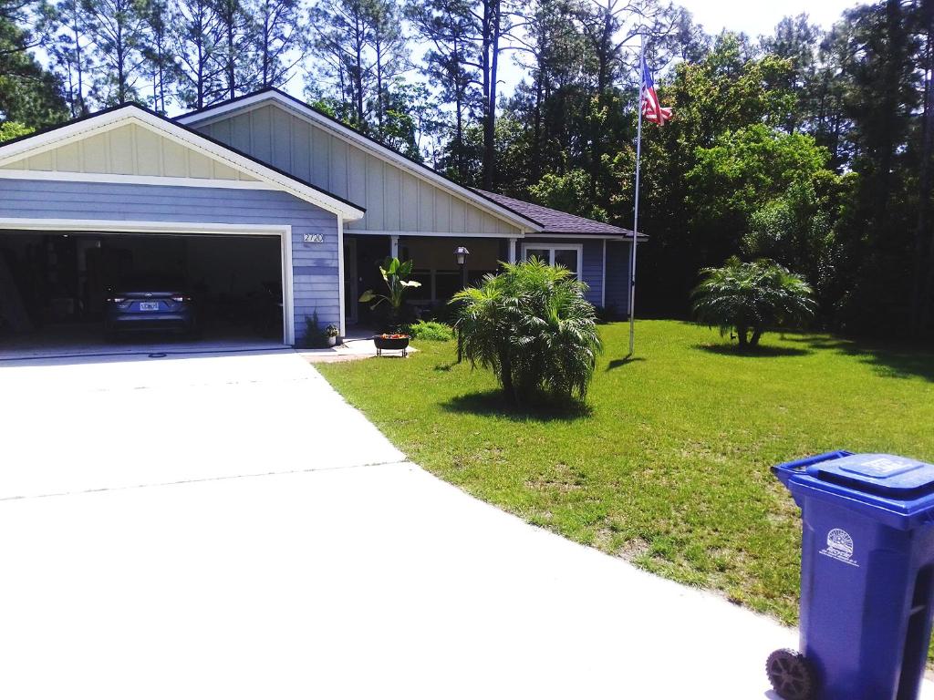 a house with a garage and a trash can in the yard at DANA ESTATE's in Saint Augustine