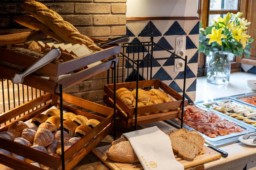 a bunch of different types of bread and pastries at Ca's Xorc Luxury Retreat - ADULTS ONLY in Sóller