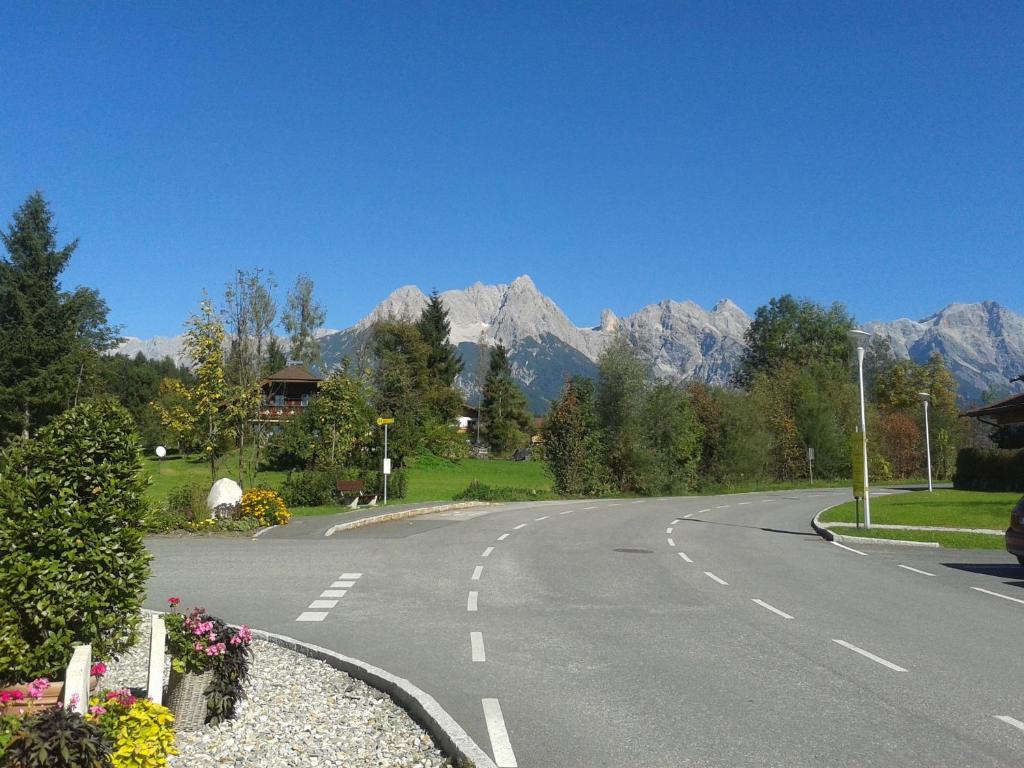 an empty road with mountains in the background at Der Winklhof in Saalfelden am Steinernen Meer