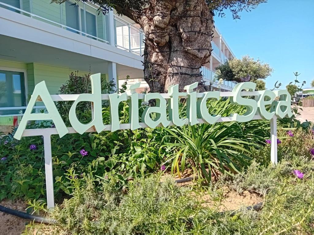 een bord voor een tuin voor een huis bij Marina Club Adriatic Gibraltar - Studio Apartment in Gibraltar