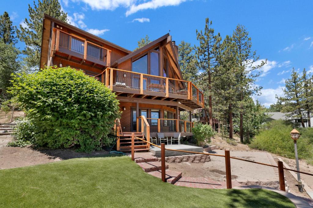 a large wooden house with a staircase leading up to it at Cove lakefront chalet #2098 in Big Bear Lake