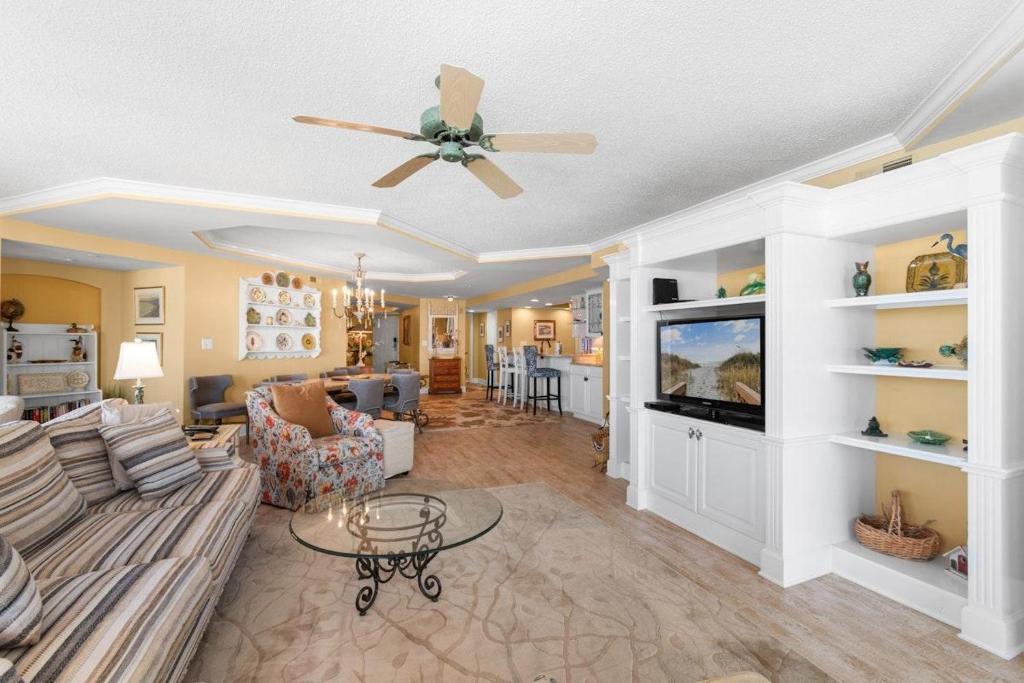 a living room with a couch and a tv at Coastal Paradise Getaway 3BR Condo Ocean View in Pawleys Island