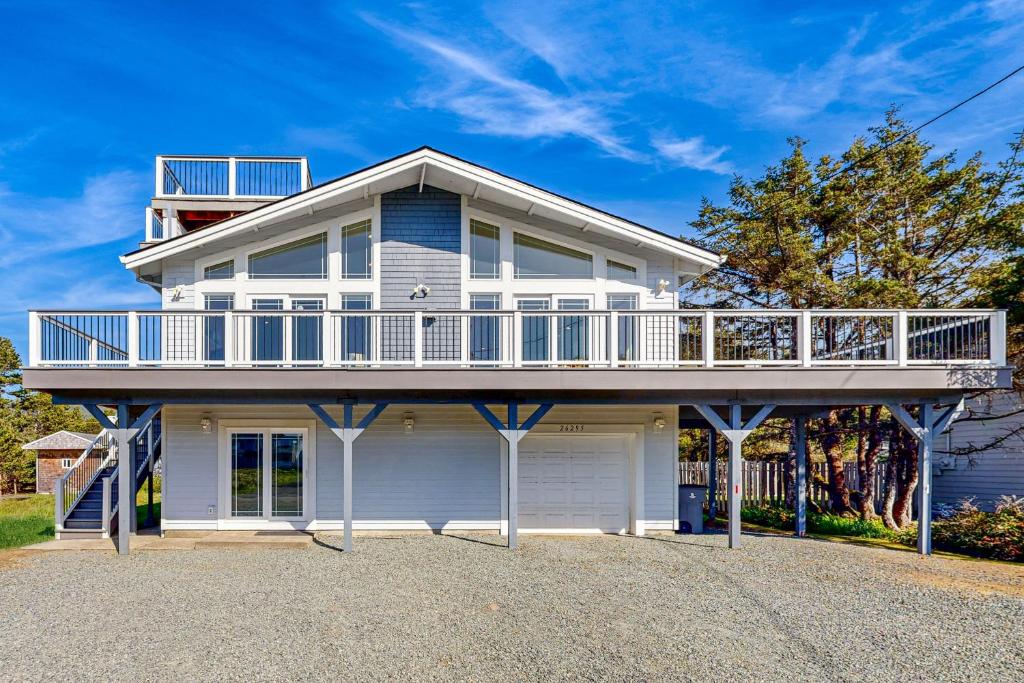 a large white house with a large balcony at Beach Escape in Rockaway Beach