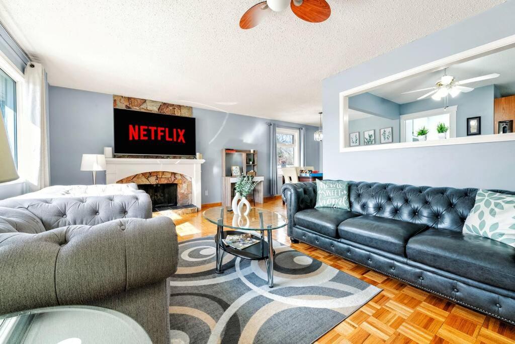 a living room with a couch and a fireplace at Comfy Getaway - Walk to West Ed Mall in Edmonton