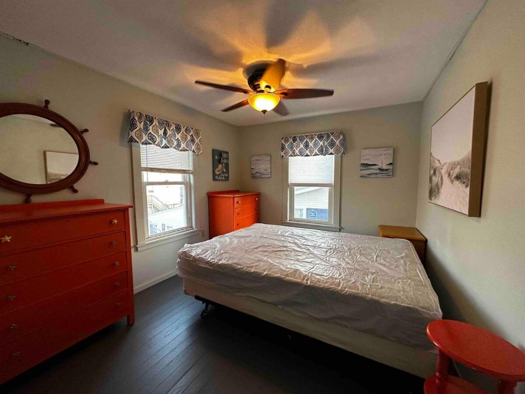 a bedroom with a bed and a ceiling fan at The Tides in Hampton
