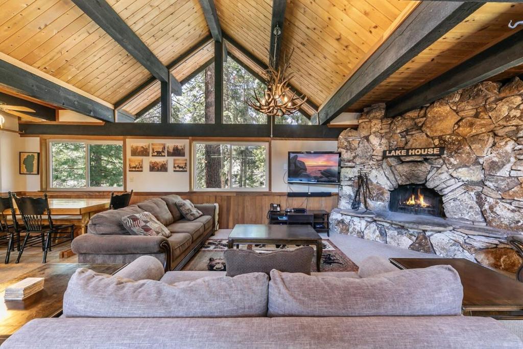 a living room with couches and a stone fireplace at Carnelian Bay 4BD Near Beach & Slopes in Carnelian Bay