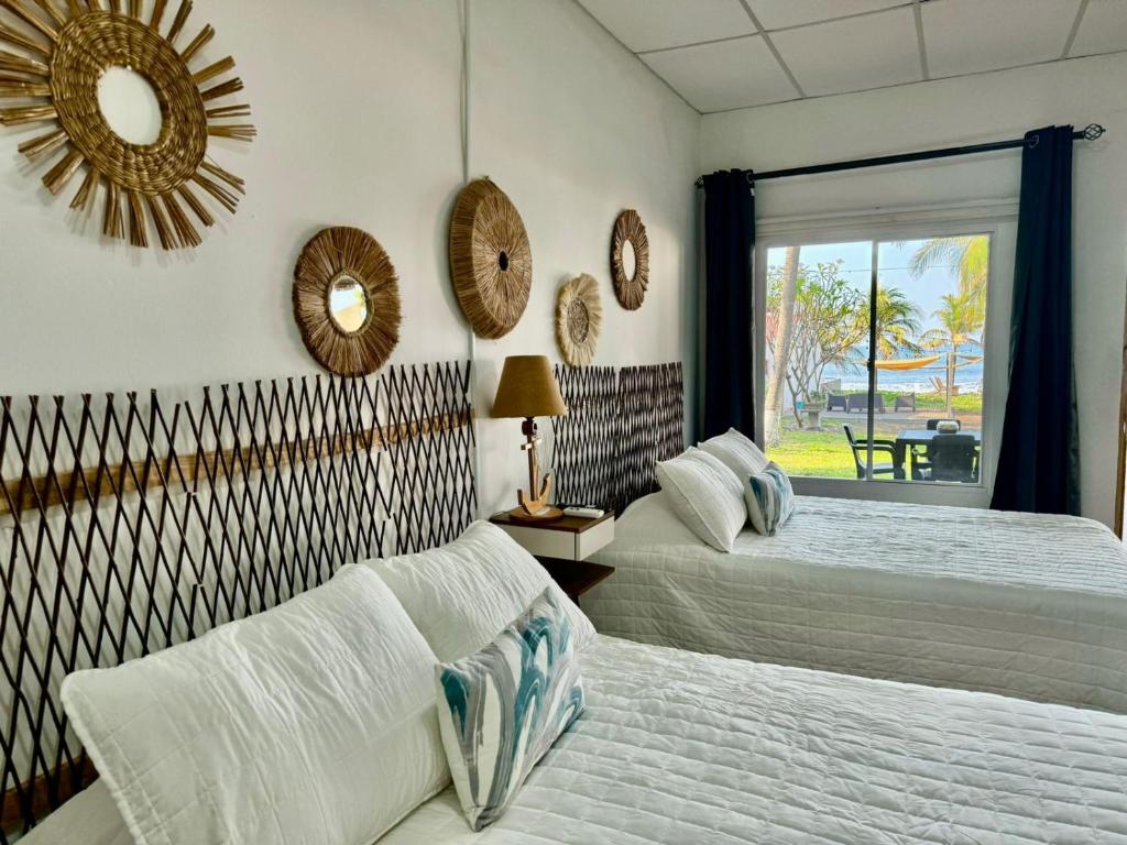 A bed or beds in a room at Lali Beach Hotel Boutique