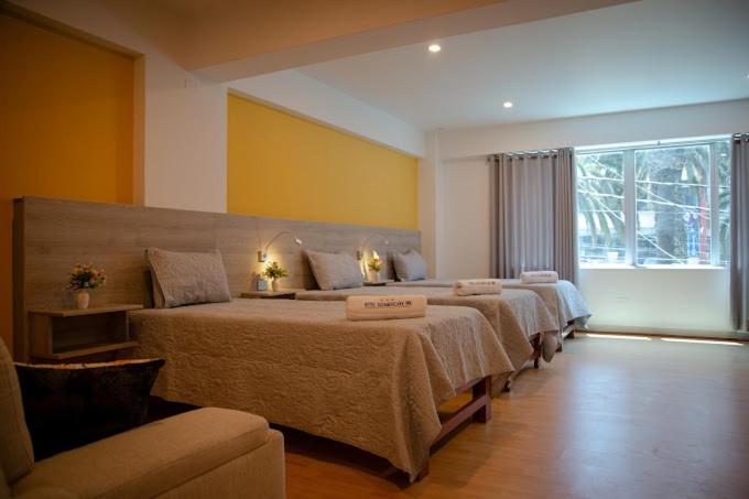 Postel nebo postele na pokoji v ubytování HOTEL SUDAMERICANA INN