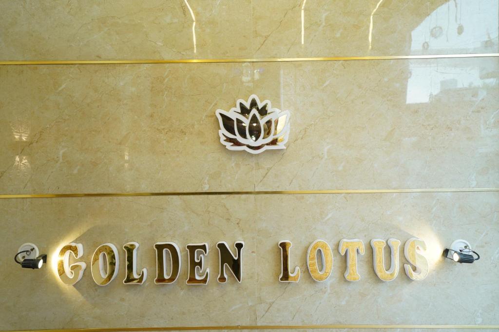 a golden lotus sign on the side of a building at Golden Lotus Varanasi in Varanasi