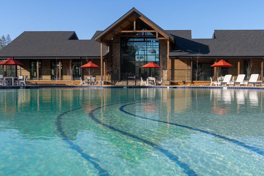 a building with a pool of water in front of it at Firefall Ranch Yosemite in Groveland