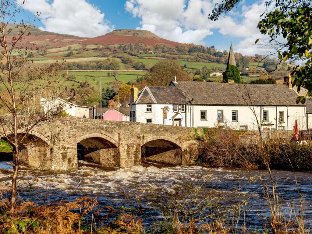 an old stone bridge over a river in a village at 2 Bed in Crickhowell 90346 in Crickhowell