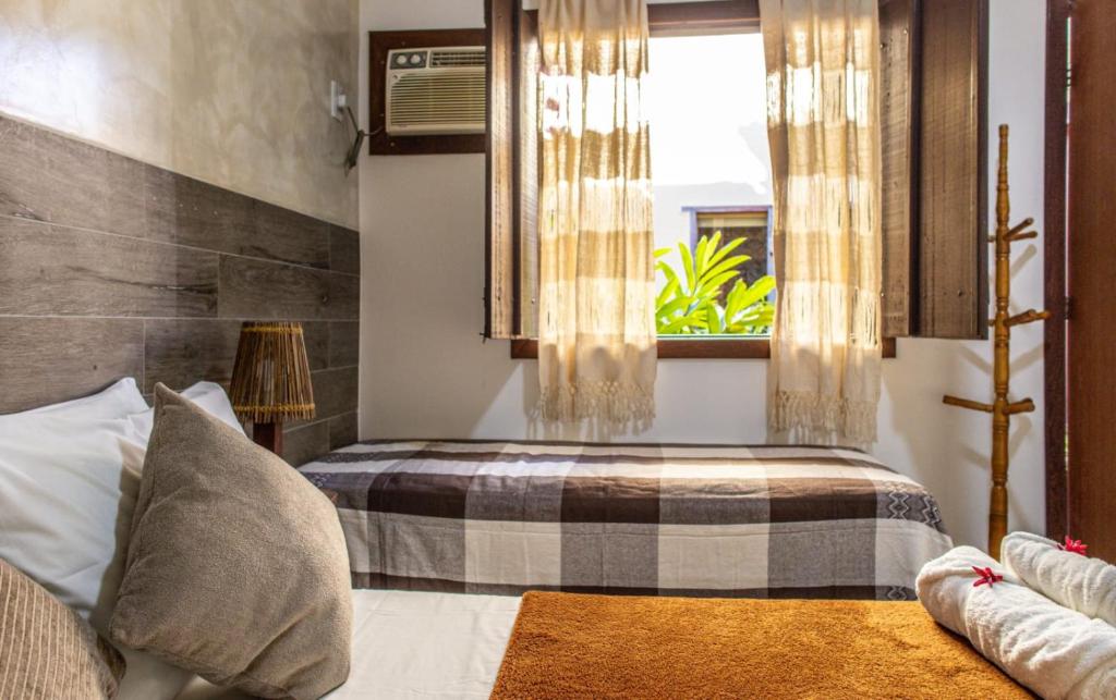 Uma cama ou camas num quarto em Pousada Das Araras