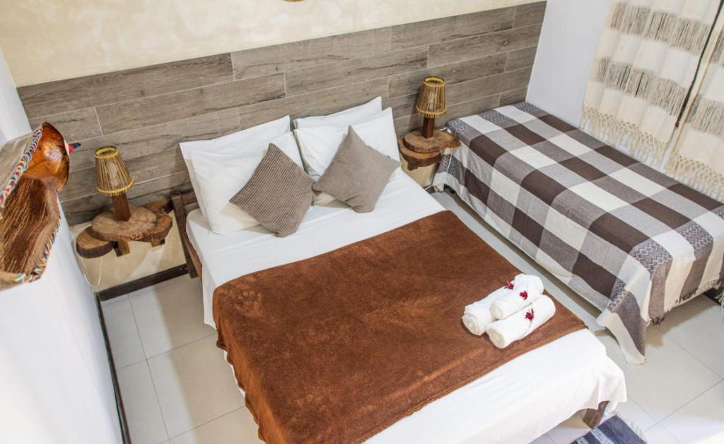 Uma cama ou camas num quarto em Pousada Das Araras