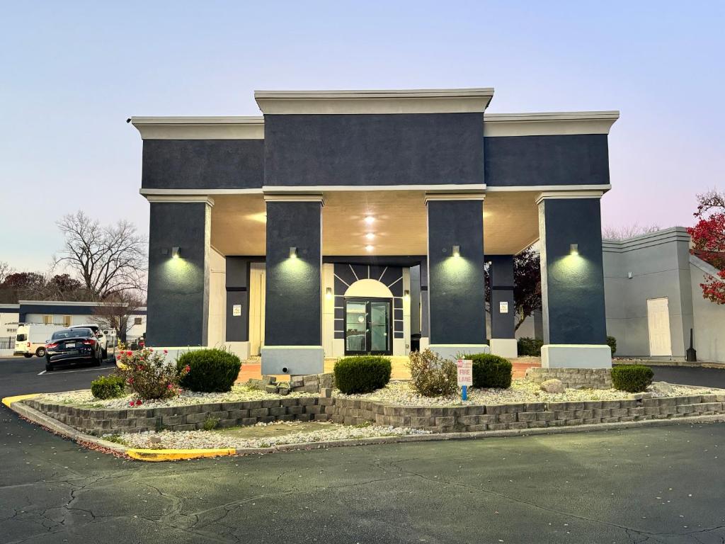 a blue building with a car parked in a parking lot at Quality Inn & Suites in Cincinnati