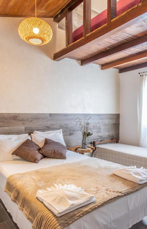Uma cama ou camas num quarto em Pousada Das Araras