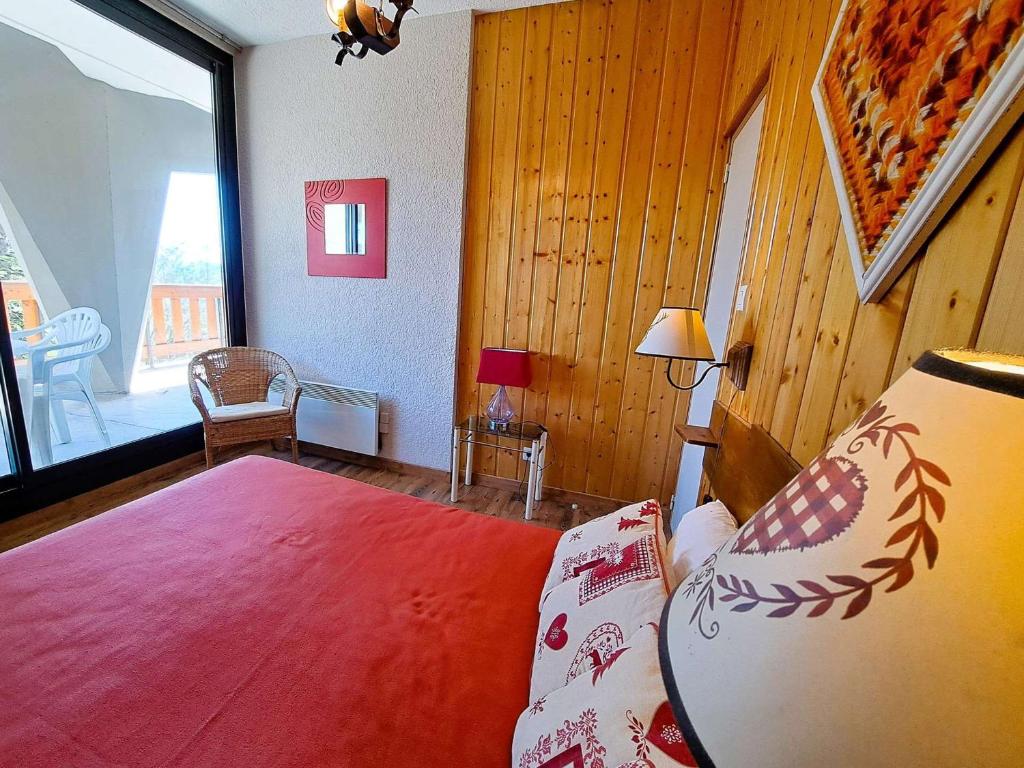 a bedroom with a bed and a large window at Appartement Pra-Loup, 3 pièces, 6 personnes - FR-1-165A-54 in Uvernet