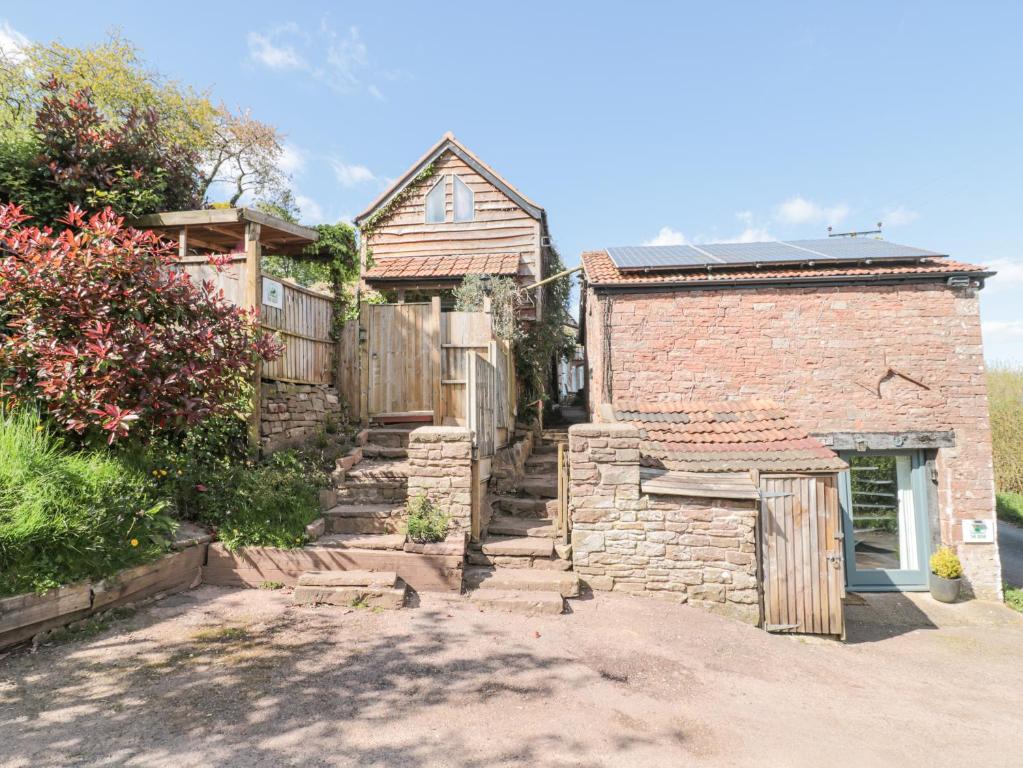 a stone house with a gate and a fence at The Boar in Blakeney