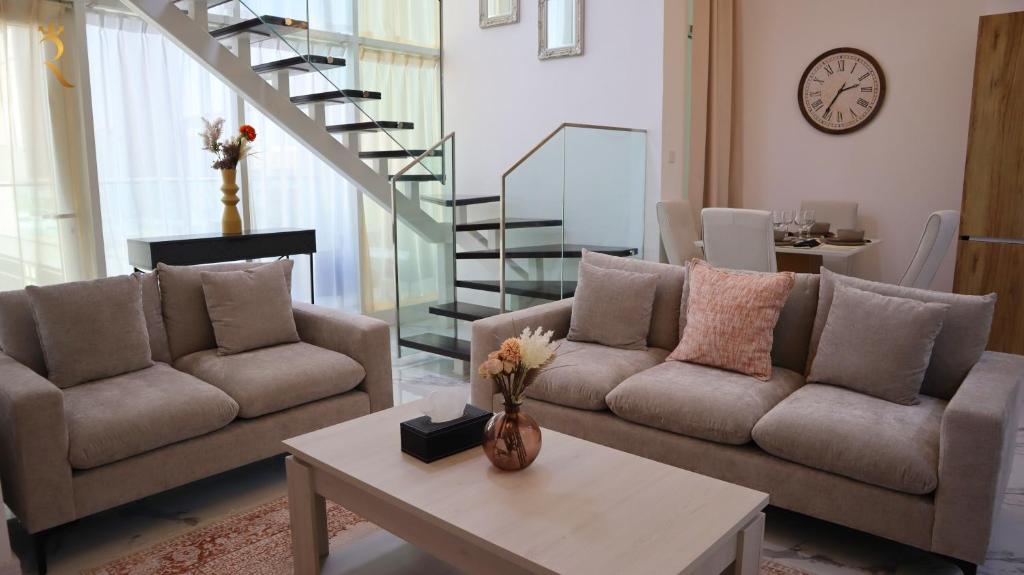 A seating area at Glen 2BR Duplex Masdar city