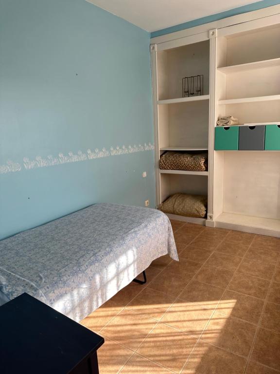 a bedroom with a bed and open shelves at Casa rural con jardín y piscina in Val de Santo Domingo
