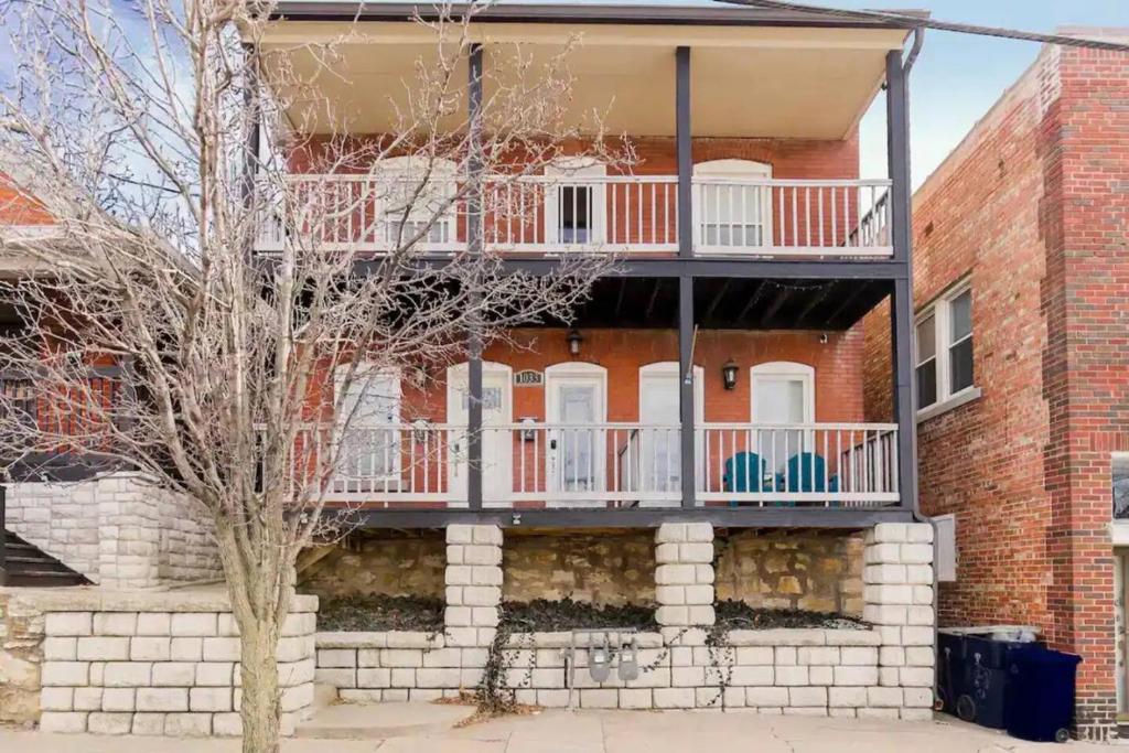 a red brick building with a balcony on it at Entire Complex with 4 bedrooms and 9 beds in Kansas City