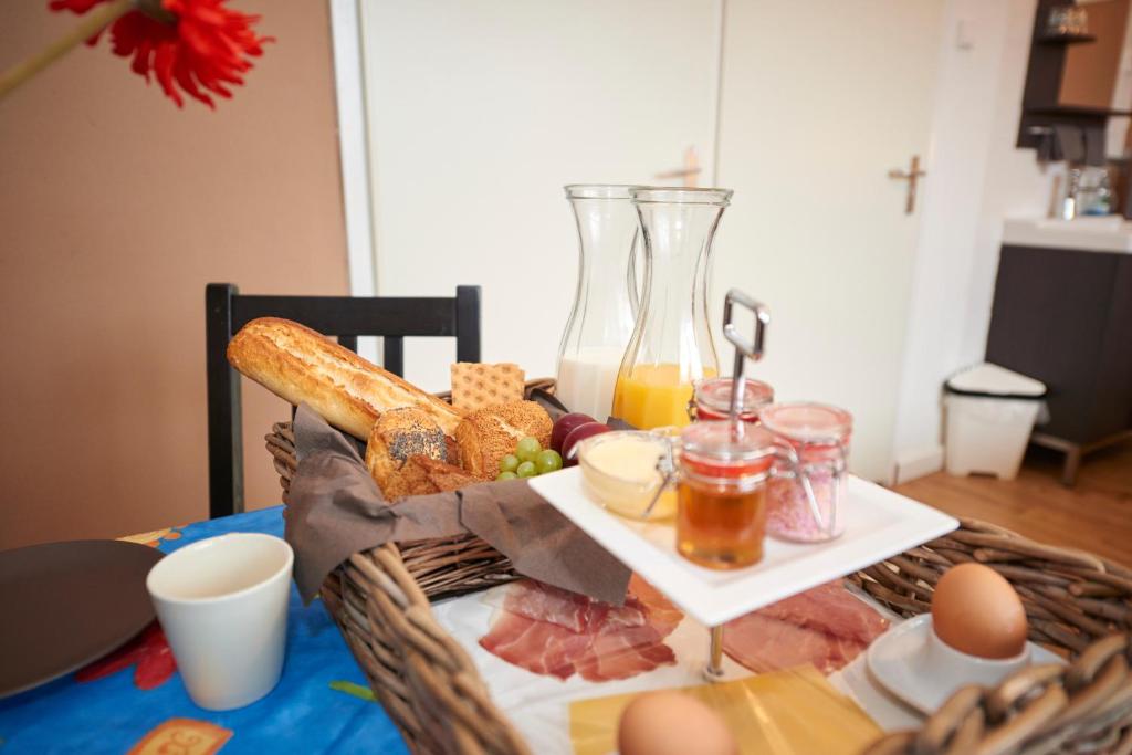 a basket of food on a table with eggs and bread at B&B HutSpot in Amsterdam